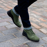 model walking wearing the boot olive with dark jeans