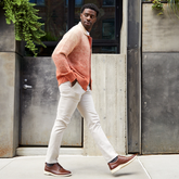 Model walking in The Original Chestnut & Cream paired with light pants and pink cardigain