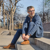 Model wearing The Original Grizzly paired with navy jacket and dress pants