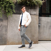 model walking wearing the slip on carbon paired with gray pants