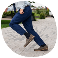 model running wearing The Slip-On in Slate paired with navy dress pants
